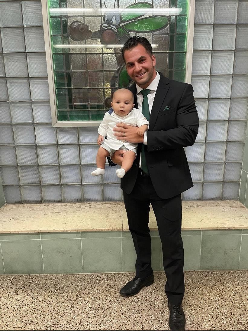 Dr. Adam Christopher and his six month old son; photo credit: Ms. Rae Allex